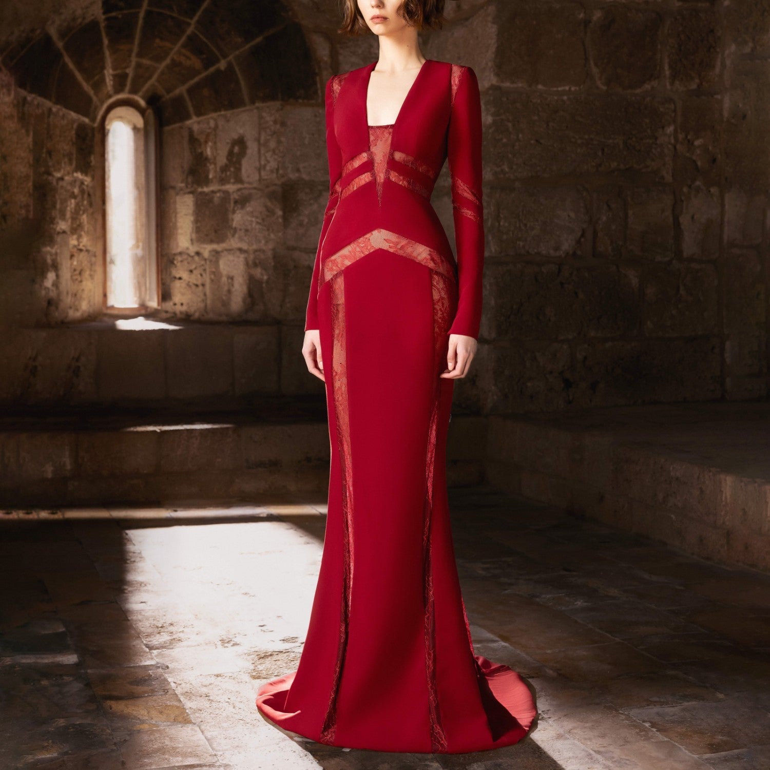 A sculpted mermaid gown in deep burgundy.